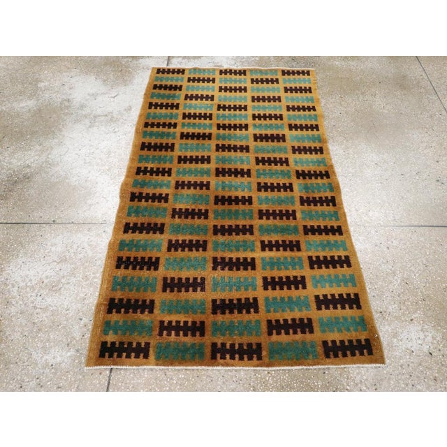 This mid-20th century Turkish Anatolian deco rug, measuring 3' 0" x 5' 2", features a bold and minimalist composition with...