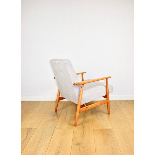 Armchair 'Lis' from the 1970s, beige colour, light wood, designed by Henryk Lis. Restored Henryk Lis armchair from 1970,...