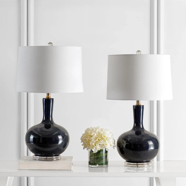 Illuminate your space with the Nilla glass table lamp set. These navy lamps, standing 26.5 inches tall, bring a blend of...