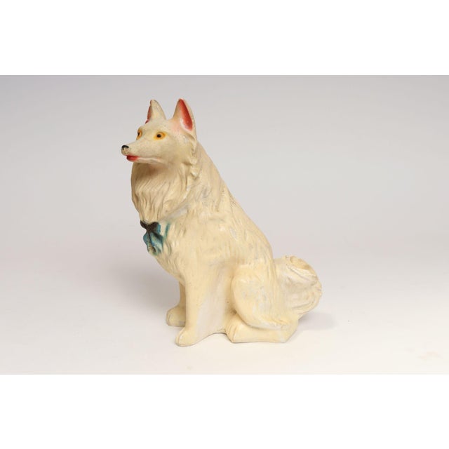Circa 1940s/50s Americana painted chalkware collie dog figurine in off-white with blue bow decoration. These figurines...