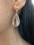 Elegant earrings featuring two pear-shaped natural morganites totaling 15.73 ct, each surrounded by 74 round brilliant...
