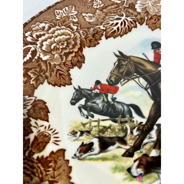This striking vintage ceramic plate captures the thrill of a traditional English fox hunt in vivid color. At the center, a...