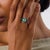 This extraordinary Art Deco style engagement ring is a bold contemporary jewel inspired by the symmetry, color, and...