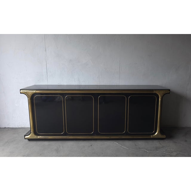 Exceptional vintage Mastercraft buffet crafted in high-gloss black lacquer and architectural solid brass that is...