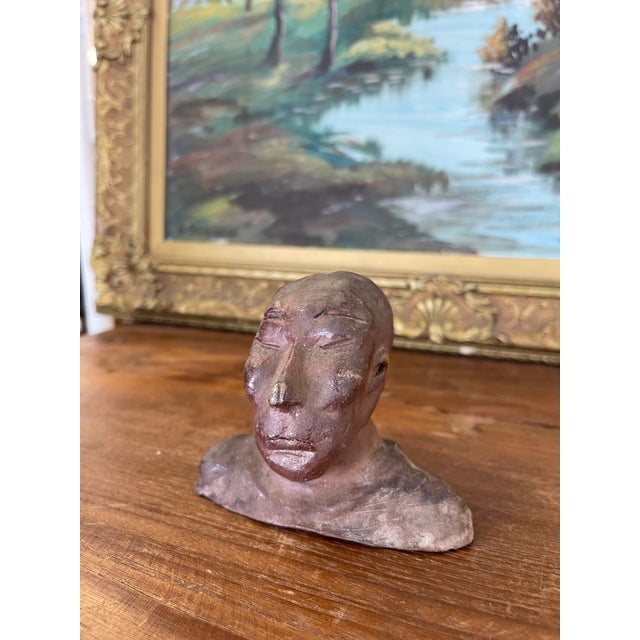 This vintage abstract bust sculpture presents a strikingly primitive yet emotive form, hand-molded in raw clay with a...