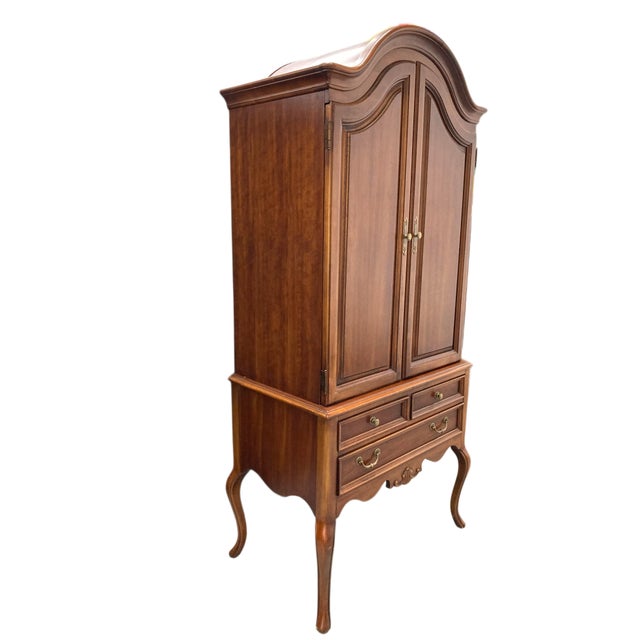 Elevate your interior with this beautifully crafted French Provincial Armoire by Lexington Furniture. The piece features...