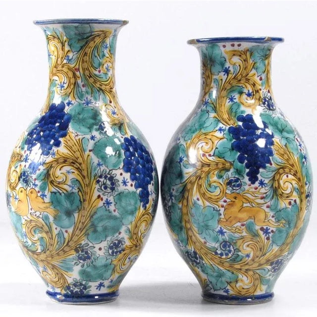 A pair of vases made of ceramics. They are decorated with hand-painted ornamental decorations. They come from...