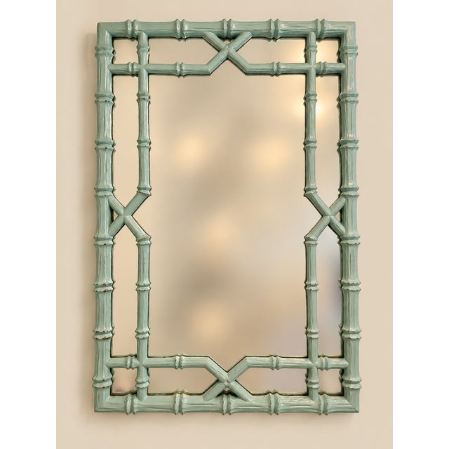 Elevate your space with this striking Mid-Century faux bamboo wall mirror. Combining classic Hollywood Regency flair with...