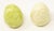 Offering a pair of ceramic glazed eggs. One is green with speckles and a swirled pattern. The other is solid cream with...