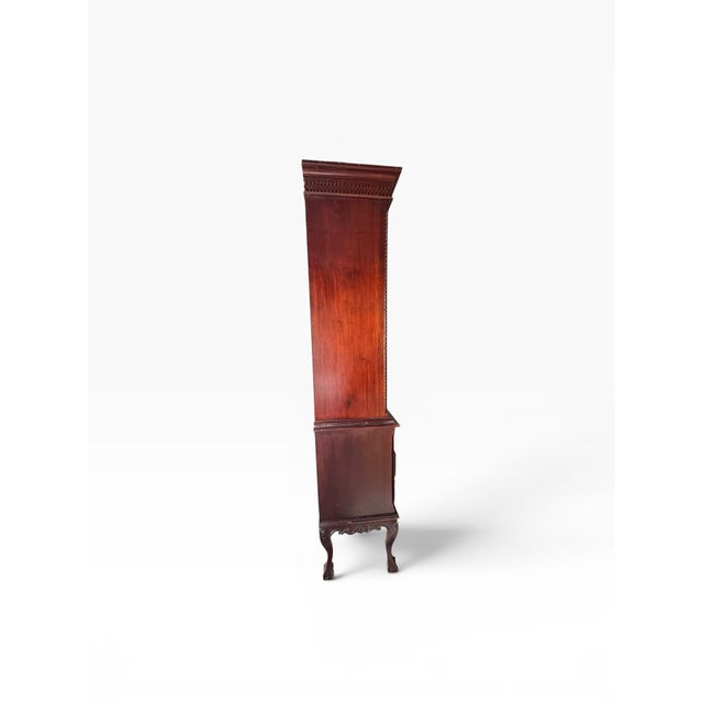A handsome Georgian-style linen press or armoire crafted in richly toned mahogany, offering both visual presence and...