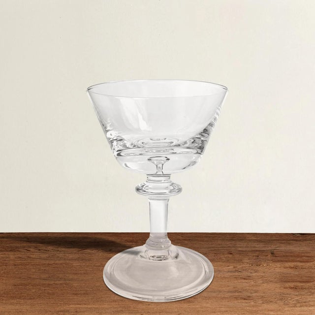 A wonderful set of eight vintage American blown crystal champagne coupes each with a captured bubble in the bottom of the...