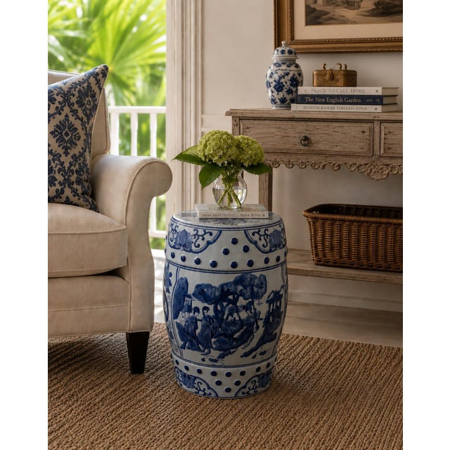 A classic blue and white porcelain garden stool, decorated with traditional Chinese scenes and motifs and stylized floral...