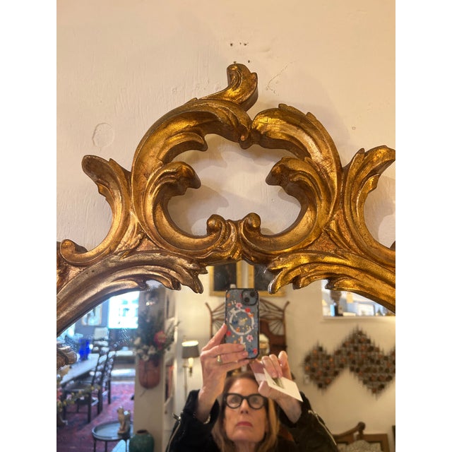 Lovely medium sized oval giltwood mirror having French curlicue style. GG Details Dimensions Height: 45 in (114.3 cm)...