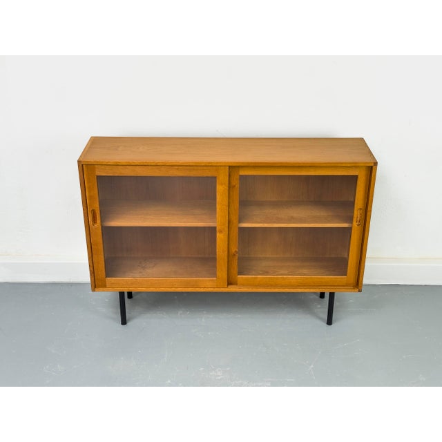 A high-quality display cabinet crafted from oiled oak with a warm, natural look. The two sliding doors feature solid wood...