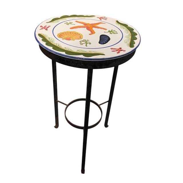 A charming and vibrant vintage Mediterranean-style martini or side table, featuring an artisan hand-painted ceramic top...