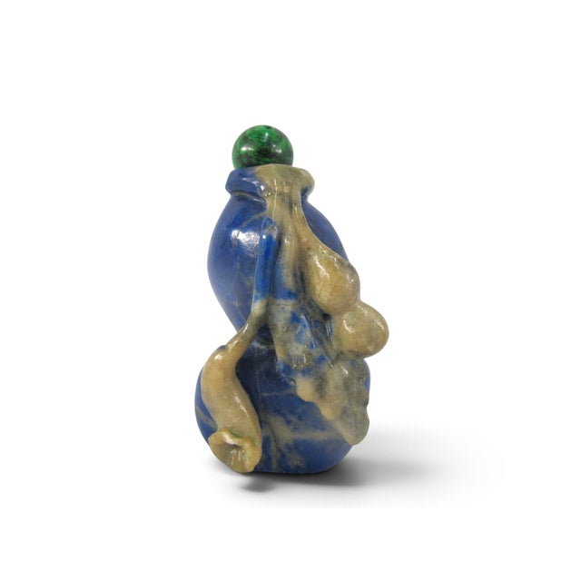 Antique Chinese snuff bottle in lapis lazuli showing carved flowers and leaves. Double gourd shaped body with green...