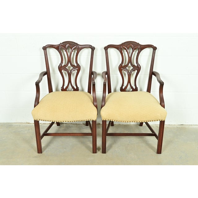 A gorgeous pair of Georgian or Chippendale style armchairs or dining captain chairs In the manner of Baker Furniture USA,...