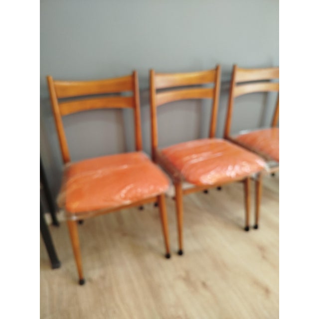 Set of 4 chairs from the 1960s made of solid beech wood, restored and treated. New upholstery in orange.