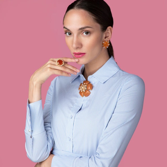 The Clementine Ring features a stunning circular semi-precious stone surrounded by an array of contrasting stones, exuding...