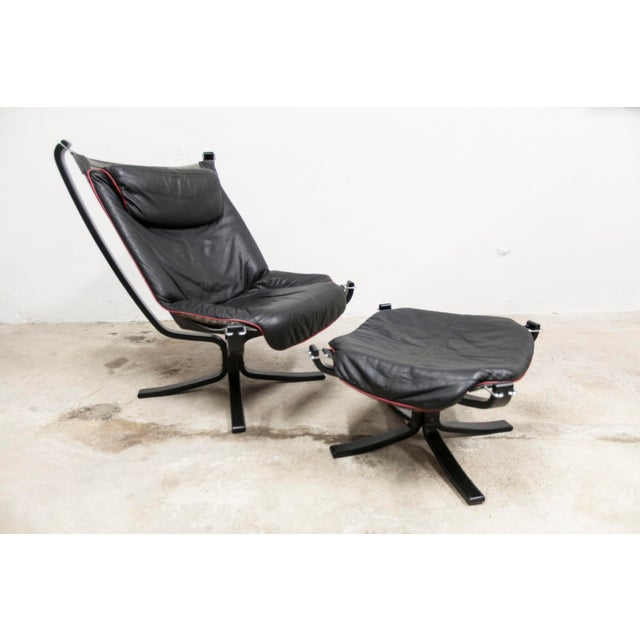 Viking armchair P97 by Sigurd Russell for Poltrona Frau, circa 1980, with matching ottoman. Both pieces are signed. The...