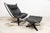 Viking armchair P97 by Sigurd Russell for Poltrona Frau, circa 1980, with matching ottoman. Both pieces are signed. The...