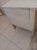 The Authentic Hollywood Regency Wood Faux Bamboo Nightstand in beige features a stylish tabletop made of wood with a...