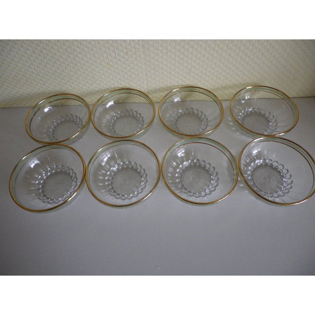 Set of 8 dessert bowls in a typical 1950s design. Each bowl is made of clear molded glass with a frosted almond green rim...