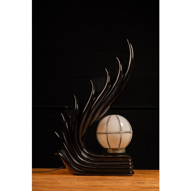 1980s Art Deco Revival Table Lamp Sweeping black lacquered body with stylized flame or wing motif and a caged opaline...