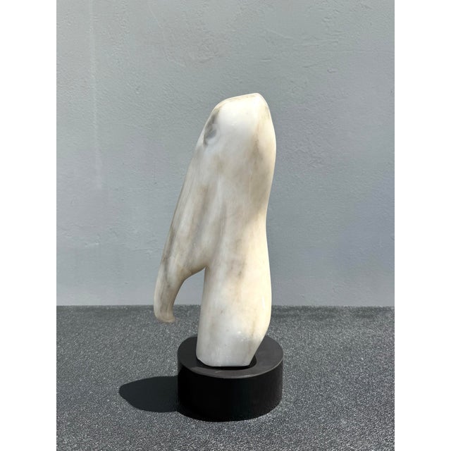 A beautifully carved vintage stone sculpture depicting a stylized pelican in an elegant, minimalist form. The artist...