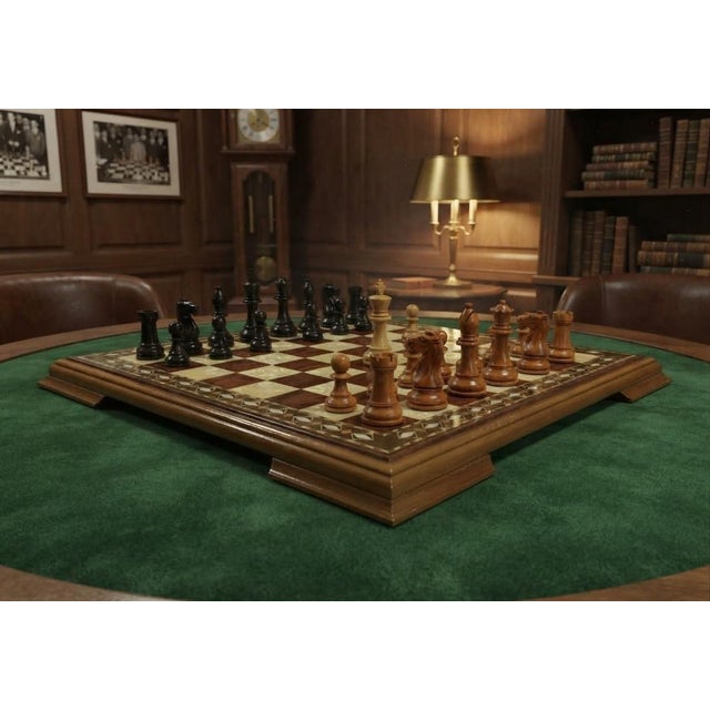 A striking 19 inch handcrafted chess board featuring luminous mother‑of‑pearl inlay paired with rich hardwood marquetry....