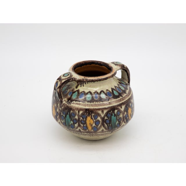 A two-handled vase from Safi, Morocco. Early 20th century. Alternating aqua and yellow leaf pattern.