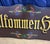 A magnificent and monumentally scaled vintage hand-painted wooden welcome sign featuring the traditional German greeting...