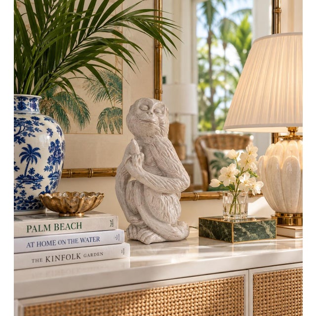 Charming 1960s vintage Italian terracotta monkey sculpture featuring a whimsical seated monkey holding a banana. Finished...