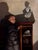 Noumena by Brad Davis | Oil on Wood Panel Portrait of a woman beside a bust and shelf items. For Sale