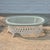 This is a lovely white wicker coffee table with an oval glass top and lattice detailing. The table is unsigned but it was...