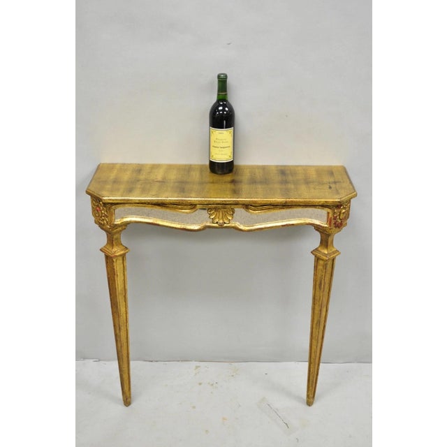 Vintage Italian Venetian Hollywood Regency Gold Gilt Wood Small Wall Mounted Console Table with Glass Mirror Skirt. Circa...