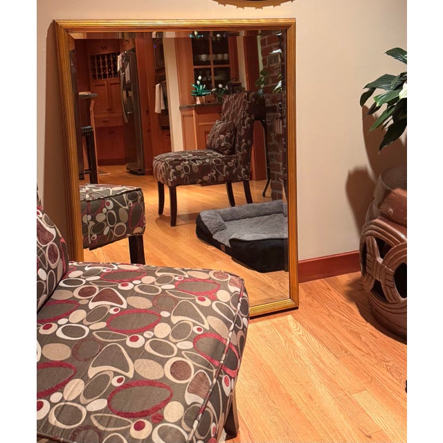 Elegant La Barge wall mirror featuring a classic gold-toned frame with subtle antiqued patina and refined linear...