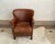 Bring timeless warmth and rich character into your space with this classic vintage distressed brown leather club chair....