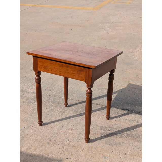 This Early 19th Century Antique Sheraton Style Side Table is a superb example of Federal-era craftsmanship, blending...