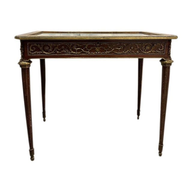 Solid rosewood display cabinet with feather marquetry and bronze ornaments and decorations. The top, with hinges and lock,...