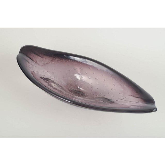 Sölvehyttan, Sweden Large art glass bowl, 1970s. Large free-form bowl in mouth-blown glass, clear with violet hue and...