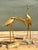This elegant pair of vintage crane sculptures epitomizes the timeless glamour of Hollywood Regency and Chinoiserie-...