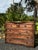 Beautiful British Colonial-style chest of drawers crafted entirely from heavy, solid wood with a warm, rich brown finish...