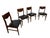 A handsome set of four Mid-Century Modern walnut dining chairs, circa 1960s, featuring clean architectural lines and a...