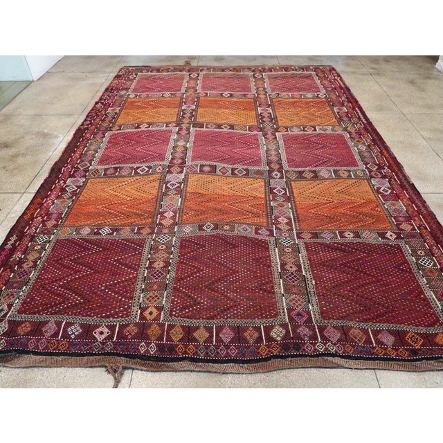 A vintage Turkish flatweave Kilim large tribal carpet handmade during the mid-20th century. Measures: 12' 4" x 17' 6"