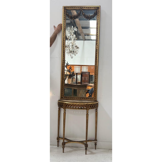 Louis xvi style console and mirror in wood and gilt stucco the console is crescent-shaped with an openwork frieze and...