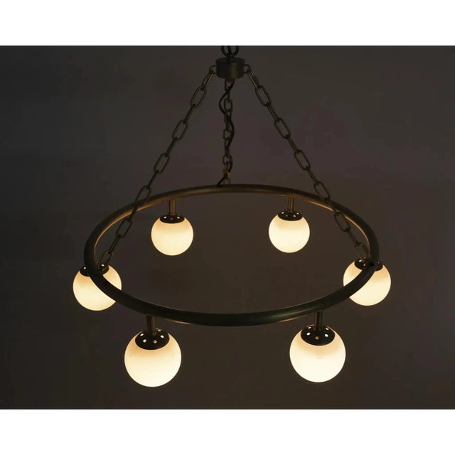 This clean and bright chandelier adds soft, diffused light and goes heavy on the style. Available in two sizes, with a...