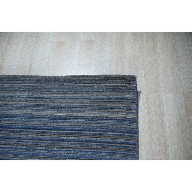 This blue polyester rug features a hand knotted pile weave, characteristic of the EORC Rugs style. Ideally suited for...