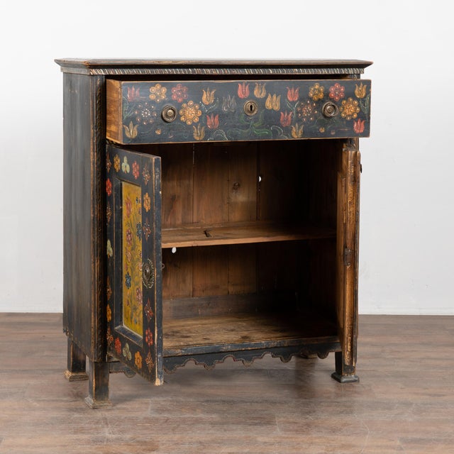 19th-century Hungarian pine cabinet or sideboard retaining its original hand-painted folk art finish. The surface features...