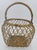 A charming vintage decorative basket crafted from heavy-gauge brass wire. This piece features an intricate, open-weave...